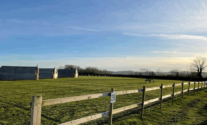 Autumn morning on campsite showing glamping pods and pitches